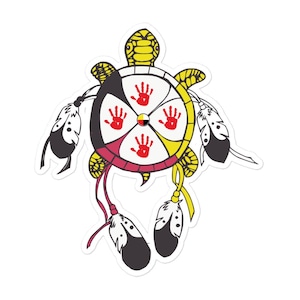May include: A sticker featuring a turtle design with a circular emblem. The emblem is divided into four sections, each with a red handprint. The turtle is yellow, and the emblem has black, white, yellow, and red accents. Feathers hang from the design.