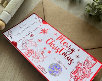 May include: A red and white Christmas scratch card with a nutcracker illustration and the text "Merry Christmas". The card has a silver scratch-off area with the text "scratch here".