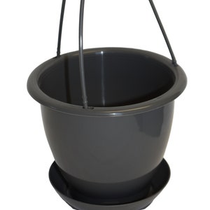 May include: A gray plastic hanging planter with a saucer. The planter has two black metal hooks for hanging.