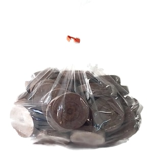 May include: A clear plastic bag filled with brown, round, compressed soil discs. The bag is tied with a red rubber band.