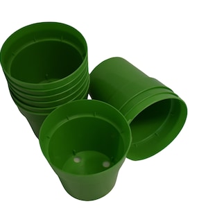 May include: A stack of ten green plastic plant pots. The pots are 4 inches in diameter and 4 inches tall.