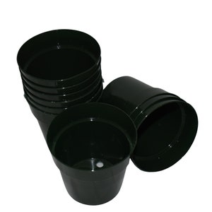 May include: A stack of dark green plastic plant pots. The pots are stacked on top of each other and are all the same size.