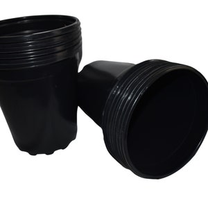 May include: A stack of black plastic plant pots. The pots are nested together and are ready for planting.