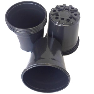 May include: Three black plastic plant pots of different sizes. The largest pot has drainage holes around the top rim.