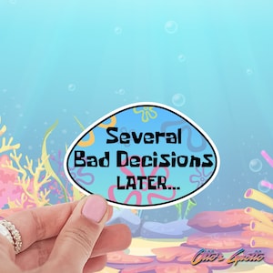 May include: A blue and yellow sticker with the text "Several Bad Decisions Later..." in black text. The sticker is shaped like a speech bubble and has a cartoonish design.
