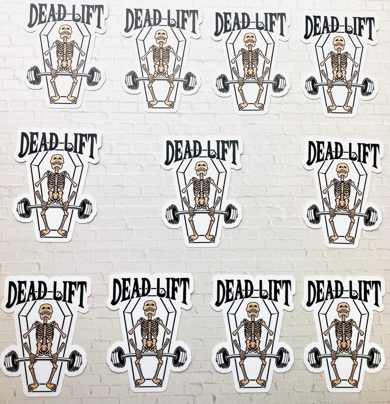 May include: Ten white stickers with a black and white illustration of a skeleton lifting a barbell inside a coffin. The text "DEAD-LIFT" is written above the coffin.