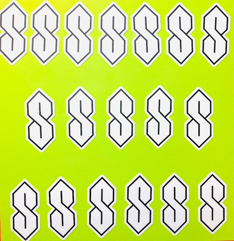 May include: A sheet of 18 white stickers with a black outline of the letter 'S' in a stylized font. The stickers are arranged in three rows of six.