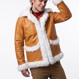 May include: A tan leather jacket featuring a white faux fur trim along the collar, front opening, cuffs, and two front pockets. The jacket is worn with brown trousers and red-tinted goggles resting around the neck, paired with spiky blonde hair.