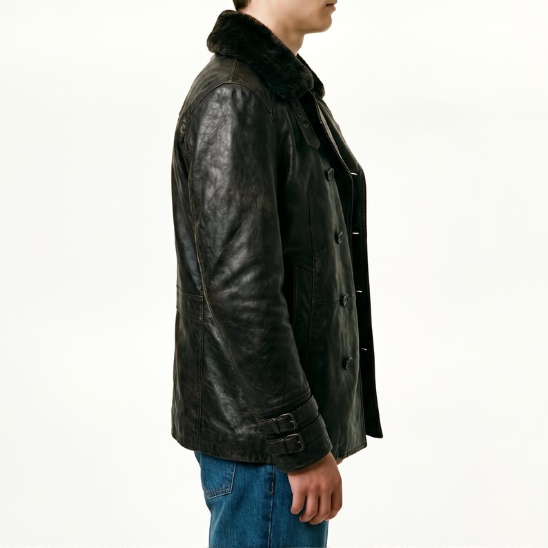 May include: A black leather jacket with a faux fur collar. The jacket has a double-breasted design with black buttons and two buckle straps on the sleeves. The jacket is worn with blue jeans.