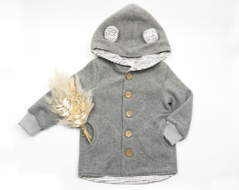 May include: A gray hooded jacket with a striped lining and wooden buttons. The jacket has two pockets and a hood with ears.