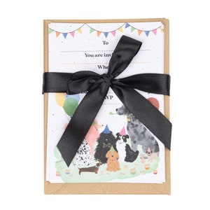 May include: A set of dog-themed birthday party invitations with a black ribbon tied around them. The invitations feature a colorful illustration of dogs wearing party hats and holding balloons.