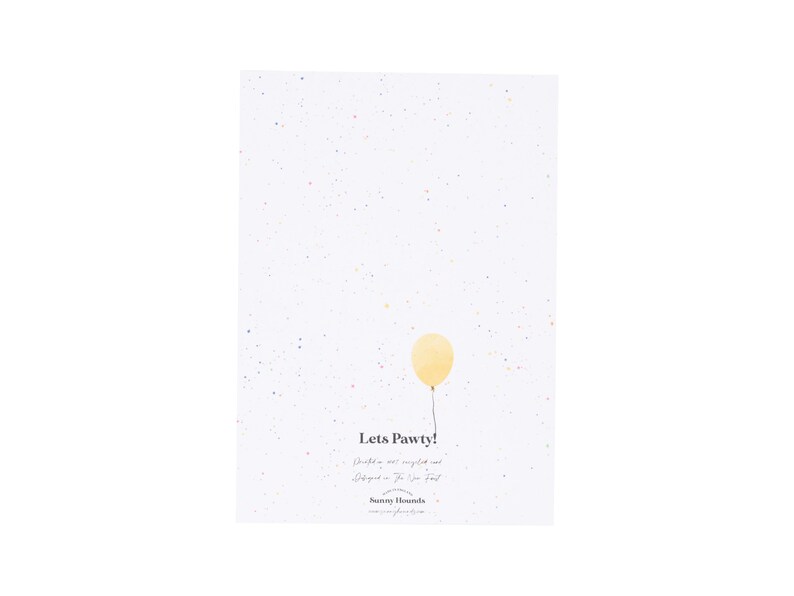 May include: A white card with a yellow balloon and confetti. The card says "Lets Pawty!" with a handwritten message below.