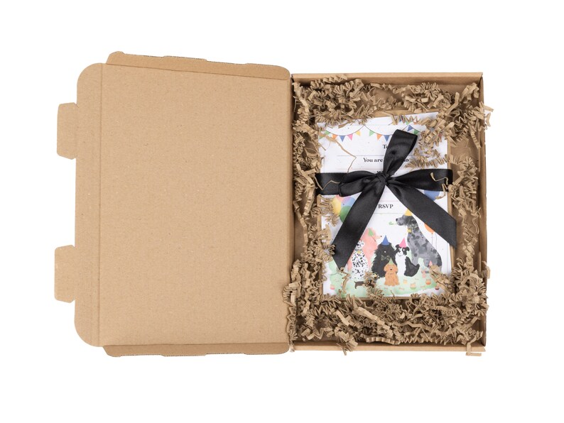 May include: A brown cardboard box with a black ribbon tied around a white card with a colorful illustration of dogs wearing party hats. The card says "You are invited to a Pawty!" and "Join P..."