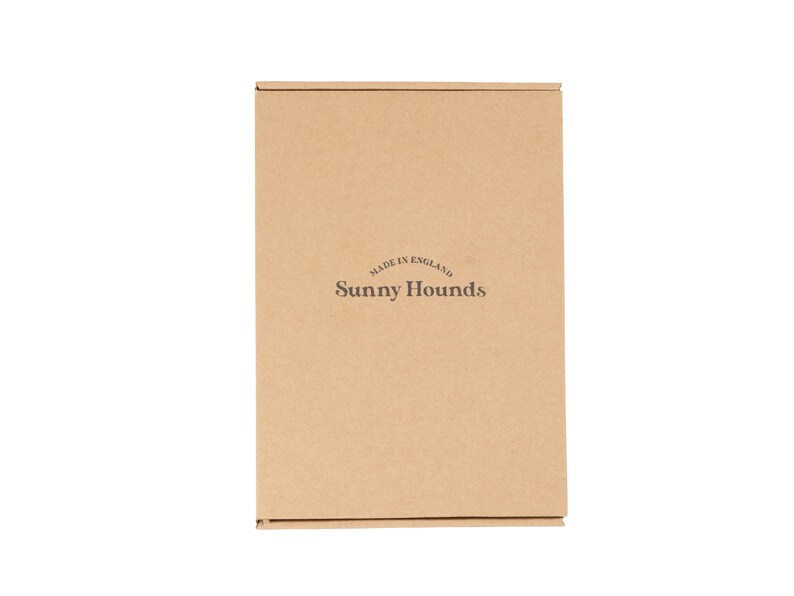 May include: A brown cardboard box with the text "MADE IN ENGLAND" and "Sunny Hounds" printed on it.