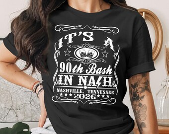 May include: Black t-shirt with a white graphic design. The design includes the text "IT'S A 90th Bash IN NAZH" with "Nashville, Tennessee 2026" below. The design has stars and decorative flourishes.
