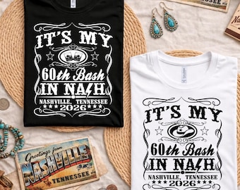 May include: A black t-shirt and a white t-shirt, each featuring a graphic print that reads IT'S MY 60th Bash IN NASH, NASHVILLE, TENNESSEE 2026. The black shirt graphic includes two glasses, while the white shirt graphic features a cowboy hat.