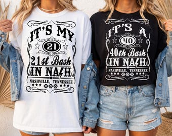 May include: Two short-sleeve t-shirts, one white and one black, featuring graphic text designs. The white shirt reads IT'S MY 21 21st Bash IN NASH NASHVILLE, TENNESSEE. The black shirt reads IT'S A 40 40th Bash IN NASH NASHVILLE, TENNESSEE.