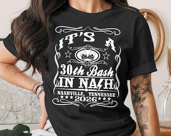 May include: Black t-shirt with a white graphic design. The design includes the text "IT'S A 30th Bash IN NAZH" with "Nashville, Tennessee 2026" below. The design also features stars and images of two glasses.