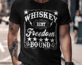 May include: Black t-shirt with the white text "Whiskey Bent Freedom Bound". The design includes stars, lightning bolts, and whiskey glasses. The shirt is short-sleeved and made of a soft material.