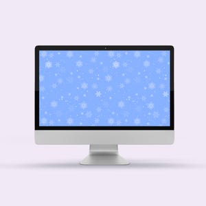 May include: A silver desktop computer with a black screen displaying a blue background with white snowflakes. The computer has a thin black bezel and a silver stand. The background is a light purple.