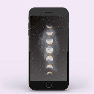 May include: A black smartphone displays a celestial-themed wallpaper. The wallpaper features a sequence of moon phases in shades of white and gold against a dark, starry background. The phone has a sleek, minimalist design.