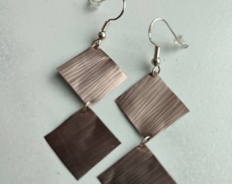 Square earrings made from recycled Nespresso brown coffee capsules