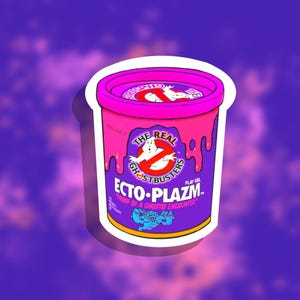 May include: A sticker featuring a container of "Ecto-Plazm" play gel from Ghostbusters. The container is purple with pink accents and the Ghostbusters logo. Text includes "The Real Ghostbusters" and "Proof of a Ghostly Encounter."