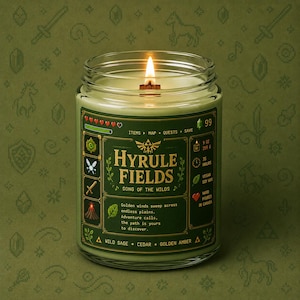 Green fantasy-inspired candle in a clear glass jar with a retro pixel adventure game style label reading Hyrule Fields. Features sage green wax, glowing wood wick flame, black lid beside the candle, and cozy green pixel background.