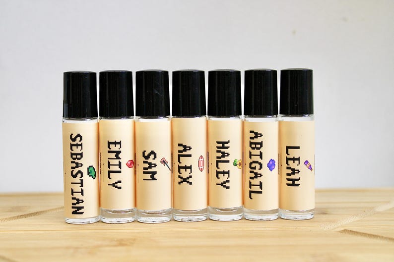 Stardew Valley inspired perfume oil with pixel art character labels including Elliott Shane Summer Winter Fall and Stardrop scents