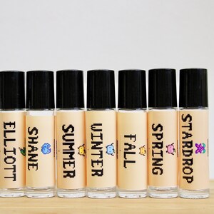 Stardew Valley inspired perfume oil with pixel art character labels including Elliott Shane Summer Winter Fall and Stardrop scents