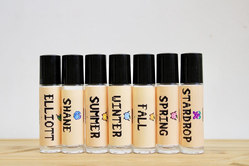 Stardew Valley inspired perfume oil with pixel art character labels including Elliott Shane Summer Winter Fall and Stardrop scents