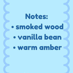 May include: A light blue card with a scalloped border displays the word "Notes:" followed by a list of scent notes: smoked wood, vanilla bean, and warm amber. A crescent moon and stars are in the bottom corner.