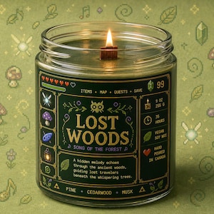Forest green fantasy-inspired candle in a clear glass jar with a retro pixel adventure game style label reading Lost Woods. Features glowing wood wick flame, woodland icons, and cozy forest aesthetic background.