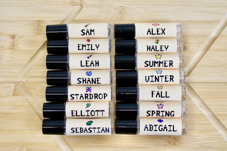 Stardew Valley inspired perfume oil with pixel art character labels including Elliott Shane Summer Winter Fall and Stardrop scents