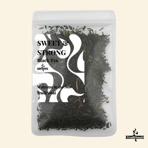 May include: A clear plastic bag filled with loose leaf black tea. The bag has a label that reads "Sweet & Strong Black Tea" with a stylized design and the text "Welcome to the New Traditional".