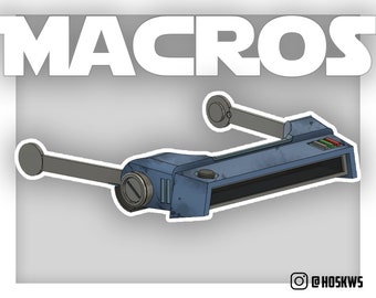 May include: A blue and gray device with two arms extending out to the sides. The device has a rectangular screen and a few buttons on the top. The device is labeled "MACROS".