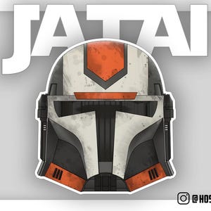 Puede incluir: Un casco blanco y naranja con una visera negra y un aspecto desgastado. El casco tiene la palabra "JATAI" escrita encima.