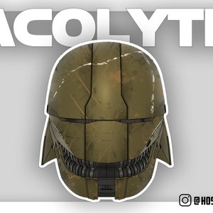 May include: A green and brown helmet with a textured surface and a visor. The helmet has a design that resembles a face with a mouth and teeth.
