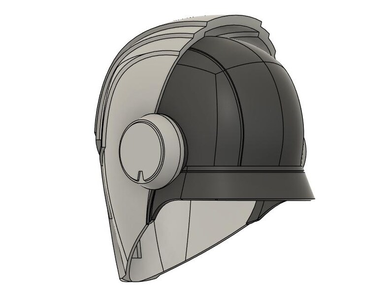 Op de afbeelding: Een tweekleurig helmontwerp, met een lichtgrijze voorkant en een donkergrijze achterkant. De helm heeft een cirkelvormig zij-element en een vizierachtige rand. Het ontwerp is futuristisch en strak, met een focus op geometrische vormen.