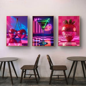 May include: Three framed art prints featuring disco-themed imagery. One shows cherries, another a martini glass, and the third a strawberry, all rendered in a mirrored, disco ball style with vibrant pink and blue neon lighting.