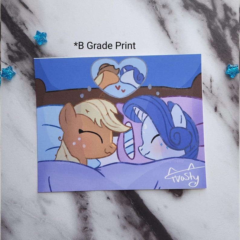 May include: A digital illustration of two cartoon ponies, one with a light brown coat and the other with a blue coat, cuddling in bed. The ponies are looking at each other with hearts in their eyes. The illustration is in a cartoon style and has a light blue background.