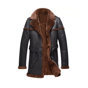 May include: A brown and black shearling coat with a button closure and a belt. The coat has a fur lining and a collar.