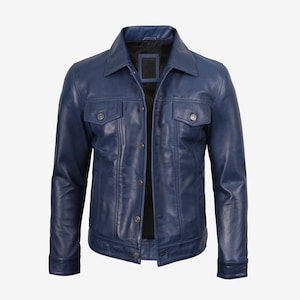 May include: A navy blue leather jacket featuring a collared neckline, two chest pockets, and button fastenings. The jacket has a classic design and a slightly worn look. The jacket is of medium weight and suitable for various weather conditions.