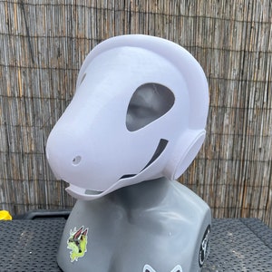 Pu&ograve; includere: Maschera di animale bianca stampata in 3D con una grande testa rotonda e una bocca larga e aperta. La maschera &egrave; su una testa di manichino grigia.