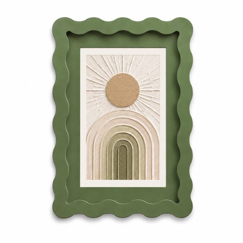 May include: A rectangular wall art piece featuring a textured beige sun and a series of concentric arches in shades of cream, tan, and olive green. The artwork is encased in a thick, matte olive green frame with a distinct wavy, scalloped edge.