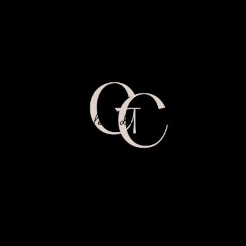 May include: A minimalist logo design featuring the intertwined letters "CC" in a soft beige color, set against a stark black background. The letters have a delicate, elegant script style, suggesting a brand identity.