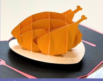 May include: A 3D pop-up card template of a roasted turkey on a plate. The card is made of paper and is designed to be cut out and assembled. The template includes SVG, PDF, and PNG files. Paper Soul POP-UP CARD TEMPLATE SVG | PDF | PNG