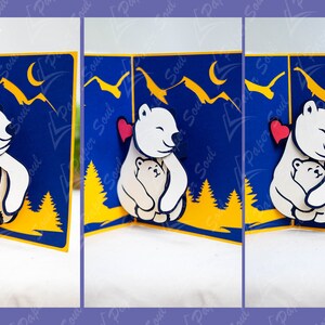 May include: A pop-up card featuring a white polar bear hugging a smaller white polar bear. The card has a blue background with yellow trees and mountains. The polar bears have red hearts on their chests.
