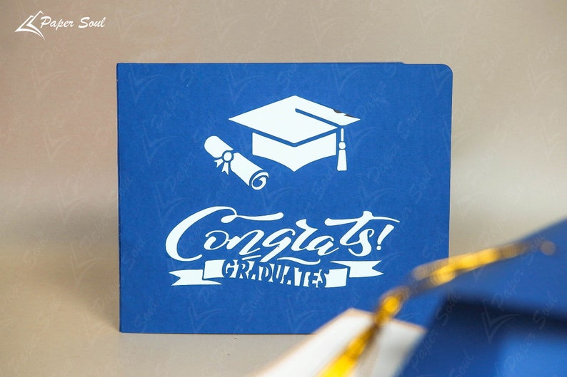 May include: A blue card with a white graduation cap, diploma, and the text "Congrats! Graduates".