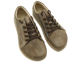 May include: A pair of brown leather lace-up shoes with a casual style.